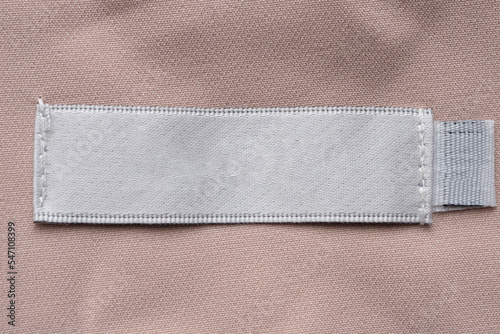 Blank laundry care clothes label on fabric texture background