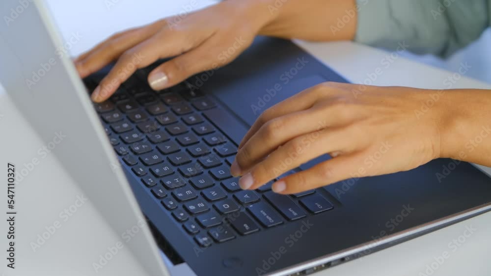 Woman typing text on laptop keyboard. Female working on modern notebook computer Woman typing text on laptop keyboard. Female working on modern notebook computer