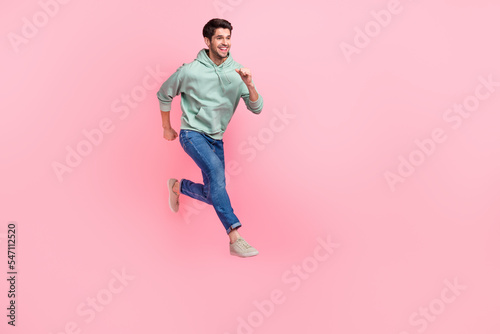 Full length photo of funky good mood man boy wear stylish outfit run empty space cool offer proposition isolated on pink color background
