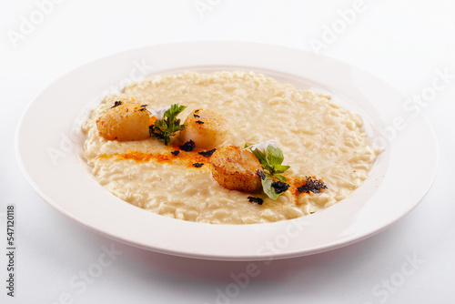 Scallops in sauce and white rice in a plate