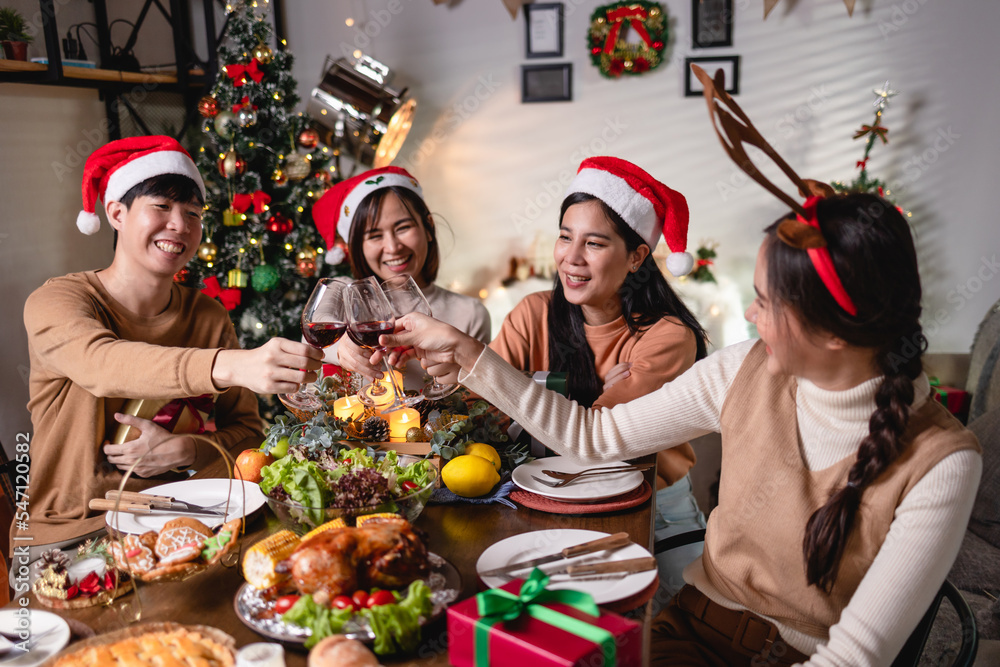 Asian people group Celebrate Christmas with red wine at home at night Asian people group Celebrate Christmas with red wine at home at night