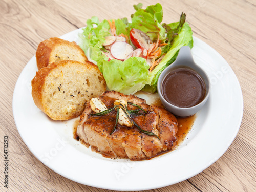 Pork sirloin steak with gravy sauce, salad and garlic bread