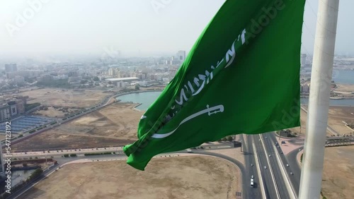 Aerial view of the Saudi Arabia National Flag waving on a pole in Jeddah photo