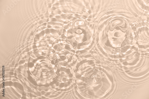 Fresh water background. Pattern with clear rippled water texture in beige, neutral color. Top view