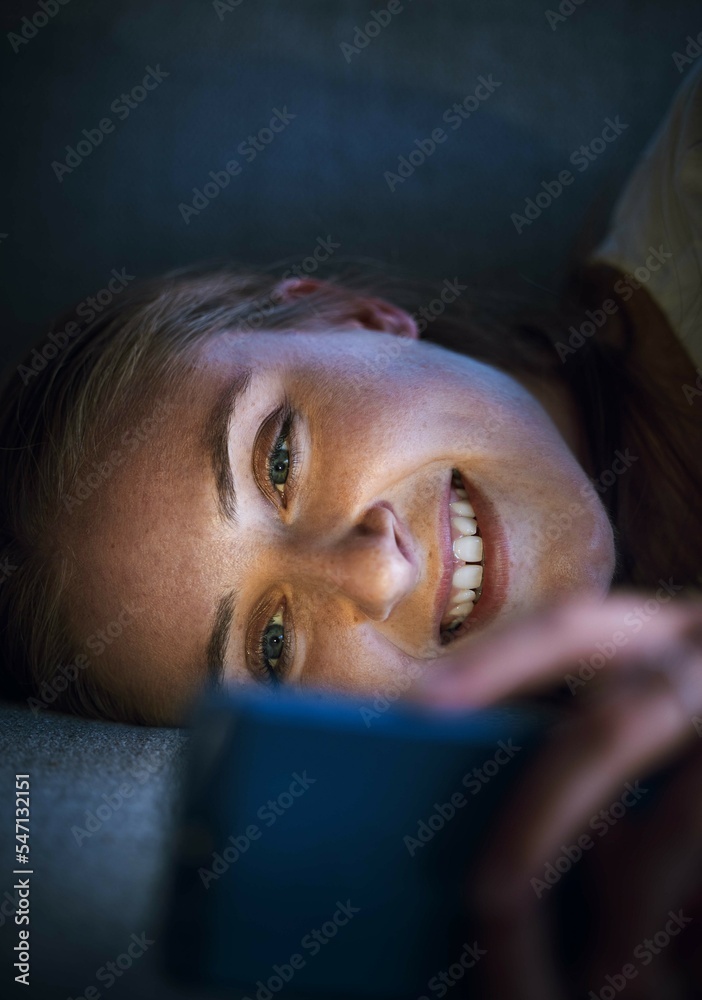 Woman, phone or lying on sofa at night in house or home living room on online dating app, social media or internet esports game. Smile, happy or relax student on mobile technology social network news Woman, phone or lying on sofa at night in house or home living room on online dating app, social media or internet esports game. Smile, happy or relax student on mobile technology social network news