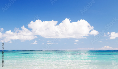 Tropical seascape white cloud above blue sea.