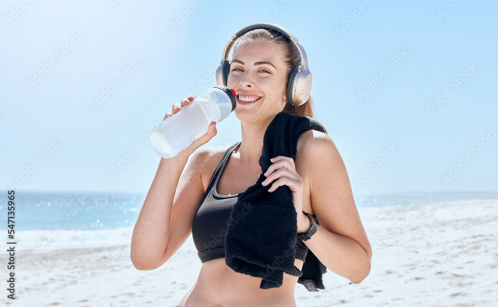 Beach, workout woman drink water portrait with music by the sea with happiness after exercise. Morning run of an athlete by the ocean with a smile after running training and relax drinking water Beach, workout woman drink water portrait with music by the sea with happiness after exercise. Morning run of an athlete by the ocean with a smile after running training and relax drinking water