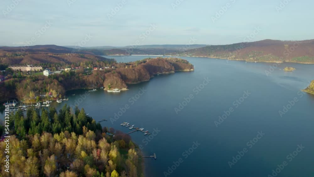 Aerial view of Lake Solina, an artificial reservoir in Poland. Landscape dominated by water, autumn forest and mountains in the nature of the Bieszcady National Park. Aerial view of Lake Solina, an artificial reservoir in Poland. Landscape dominated by water, autumn forest and mountains in the nature of the Bieszcady National Park.