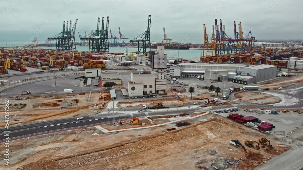 Drone of cargo commercial dock, industrial port with containers and big cranes. Moving forward on urban logistic maritime warehouse. Drone of cargo commercial dock, industrial port with containers and big cranes. Moving forward on urban logistic maritime warehouse.