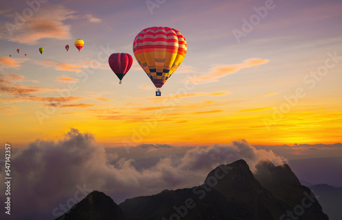 Colorful hot air balloons flying over mountain at Doi Luang Chiang Dao at sunset time in Chiang Mai, Thailand. © somchairakin