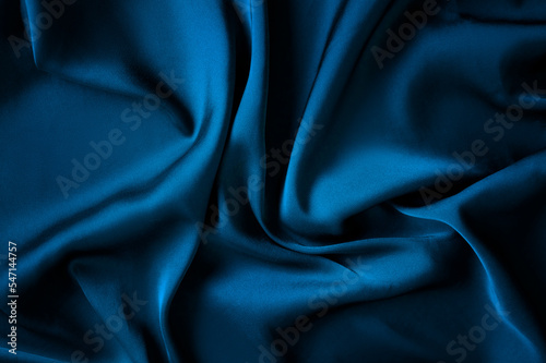 Texture, background, pattern. Texture of blue silk fabric. Beautiful blue silk fabric. dark blue background