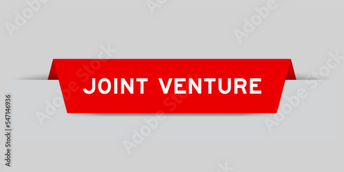 Red color inserted label with word joint venture on gray background