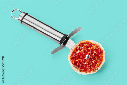 Pizza knife. Modern art collage. Salami pepperoni pizza and pizza knife. Modern food concept. photo