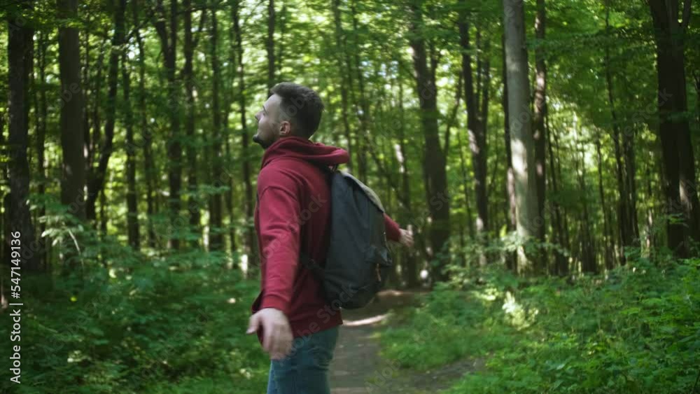 Unity with nature. Man enjoying walk in forest Unity with nature. Man enjoying walk in forest