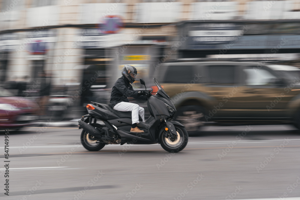 Man driving a scooter in the city