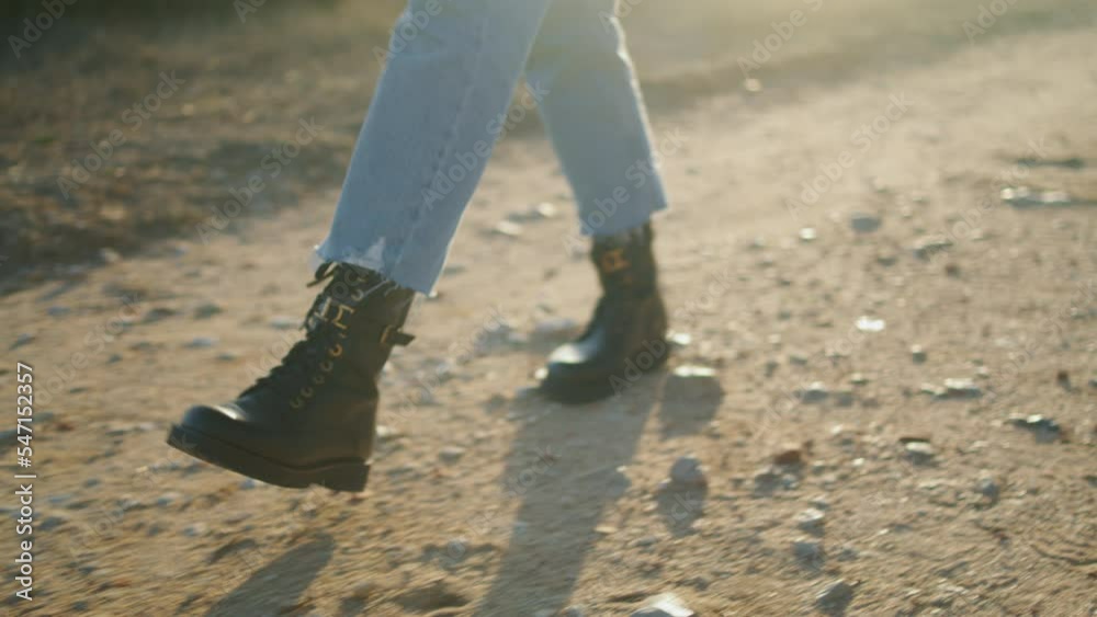 Unknown girl going road countryside closeup. Woman shoes making steps at nature Unknown girl going road countryside closeup. Woman shoes making steps at nature