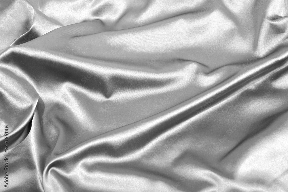 Smooth rippled elegant grey silk or satin luxury texture, close up. Closeup of wavy fabric abstract background