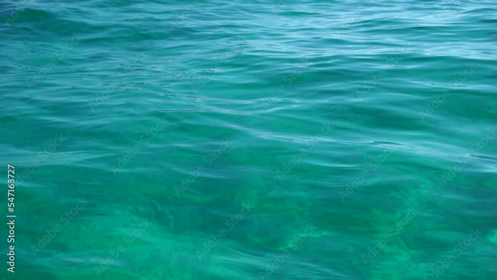 Abstract. Small waves in crystal clear azure sea on a sunny day. The concept of an ideal place for summer travel and relaxation. Abstract. Small waves in crystal clear azure sea on a sunny day. The concept of an ideal place for summer travel and relaxation.