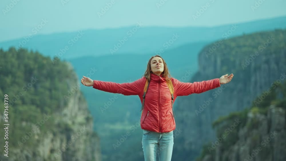 Happy joyful woman on top of mountain enjoying beautiful view, standing with open arms, hike in canyon national park. Grayhound Tazi Canyon famous touristic place in Turkey.