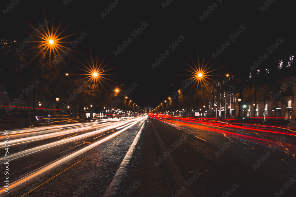 Scenic view of traffic light trails on Champs Elysee in Paris at night