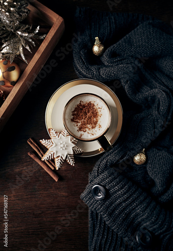 Cup of latte coffee with cinnamon and gingerbread cookie for Christmas. Flat lay