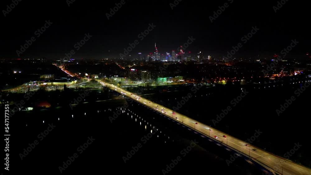 Drone view of the Metropolis Building at night and a street with heavy traffic. Crossroad Night capital of Warsaw Europe Poland Drone view of the Metropolis Building at night and a street with heavy traffic. Crossroad Night capital of Warsaw Europe Poland