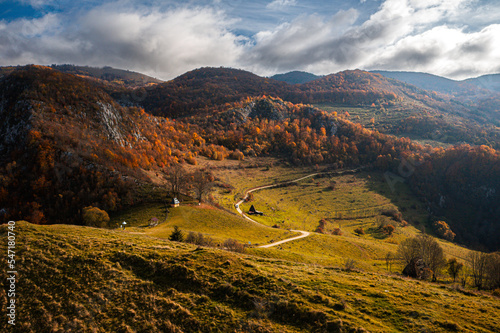 Visit Transylvania, Romania. Aerial view of Dumesti village with traditional old houses at the bottom of Apuseni Mountains in autumn color. photo