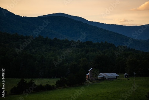 Scenic shot of grass fields and mountain silhouettes in Madison County, Virginia, USA during dusk photo