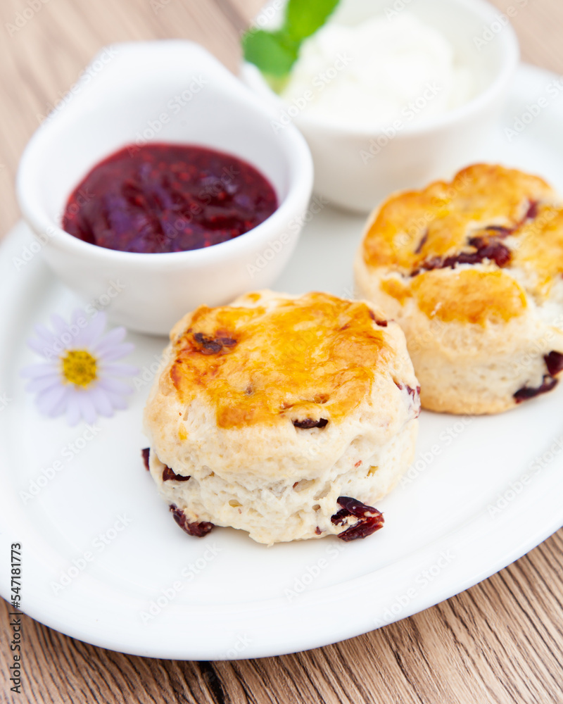 Cranberry scone set with raspberry jam and clotted cream Cranberry scone set with raspberry jam and clotted cream