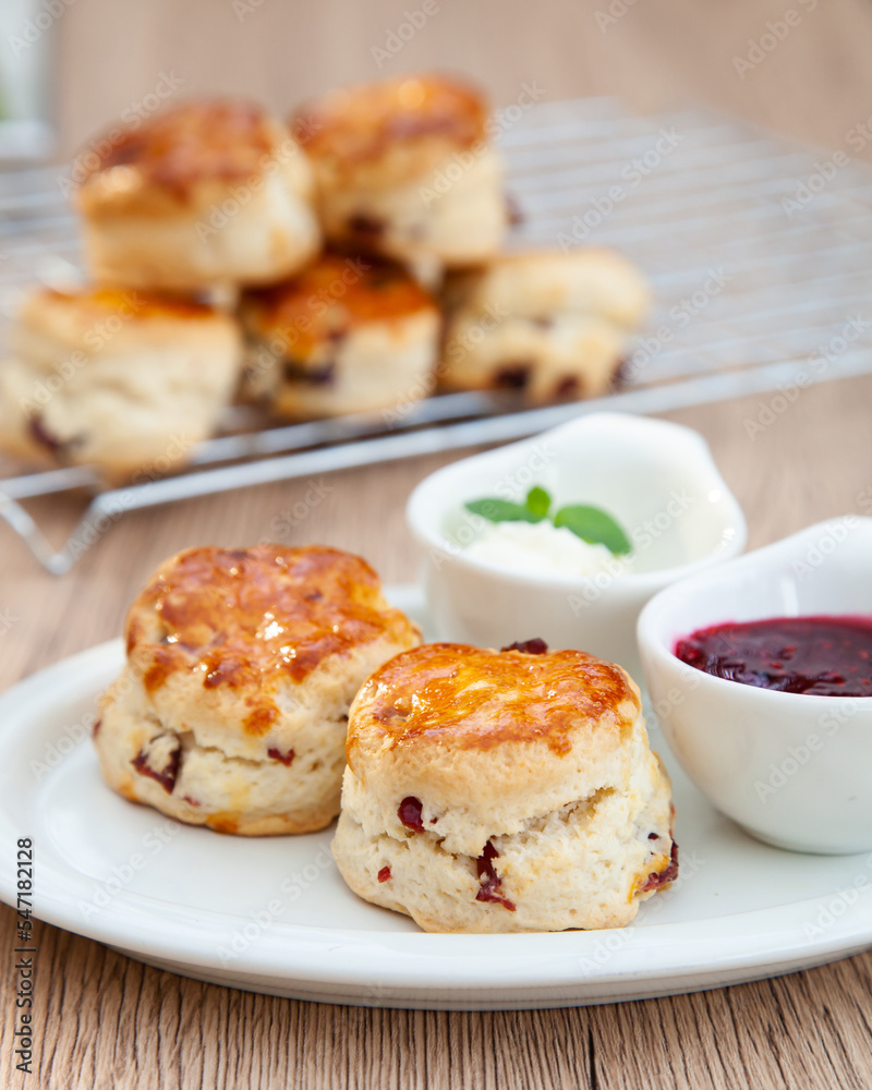 Cranberry scone set with raspberry jam and clotted cream Cranberry scone set with raspberry jam and clotted cream