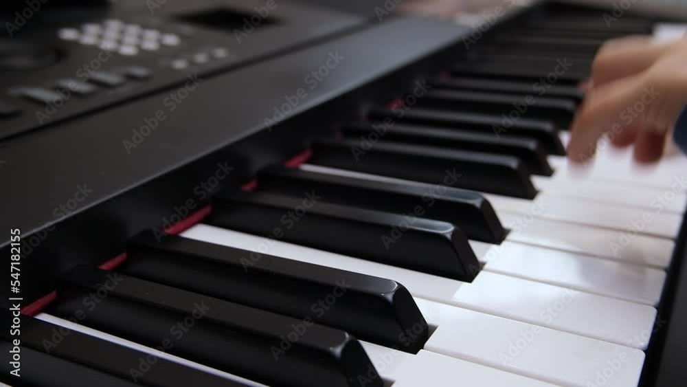 Children's fingers play on the keys of a piano synthesizer. Selective focus on piano keys Children's fingers play on the keys of a piano synthesizer. Selective focus on piano keys