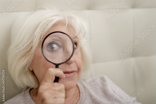 Senior woman with magnifying glass