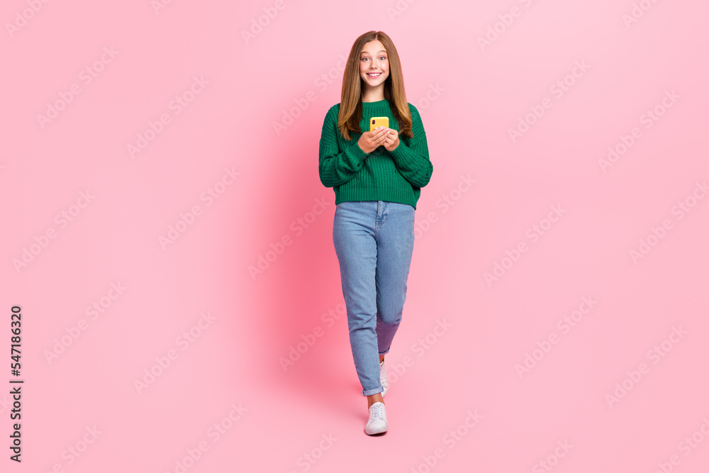 Full length photo of adorable sweet young lady wear green sweater chatting twitter facebook telegram isolated pink color background Full length photo of adorable sweet young lady wear green sweater chatting twitter facebook telegram isolated pink color background