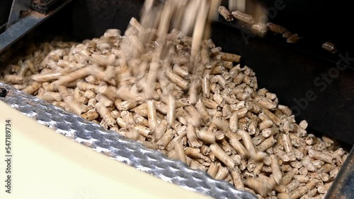 closeup of filling up a stove with wood pellets
