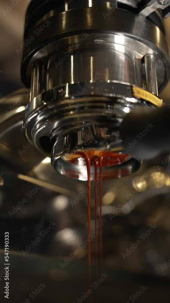 A coffee maker pours coffee close-up