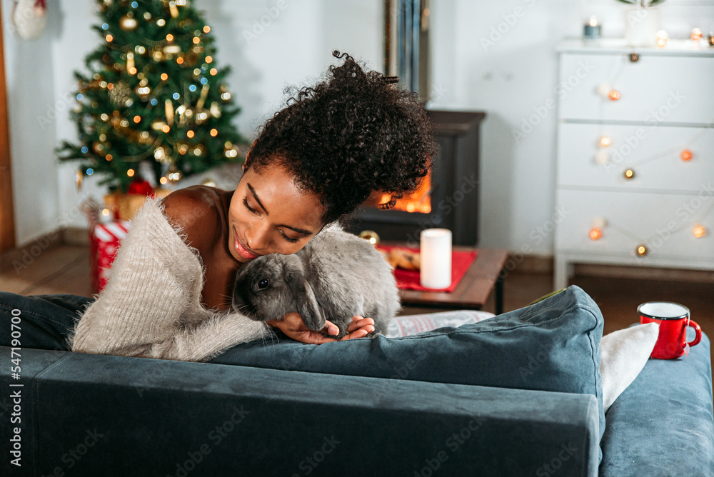Black woman with rabbit on Christmas