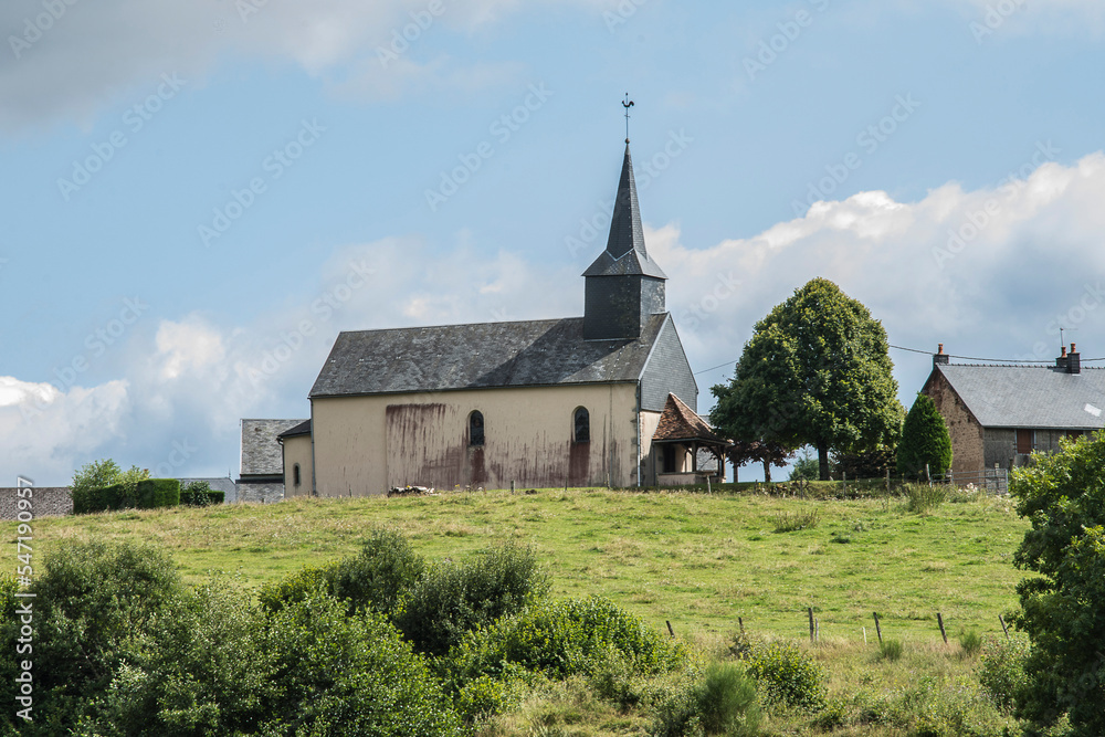 small, white village church on a hill in the Morvan village of Gien-sur-Cure in France in summer small, white village church on a hill in the Morvan village of Gien-sur-Cure in France in summer