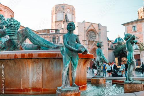 VALENCIA, SPAIN - October 16, 2022: Fountain Rio Turia on Square of the Virgin Saint Mary, Valencia Cathedral, Basilica of Virgen the Helpless.  photo