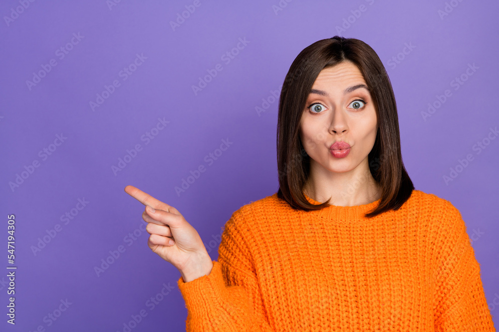 Portrait of lovely nice lady pouted lips direct finger empty space offer isolated on purple color background Portrait of lovely nice lady pouted lips direct finger empty space offer isolated on purple color background