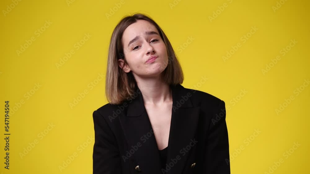 4k video of young woman thinking over yellow background. 4k video of young woman thinking over yellow background.
