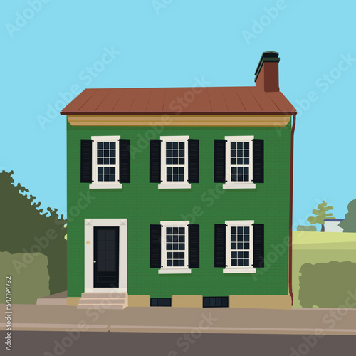 Green classic two-storey house on the background of nature