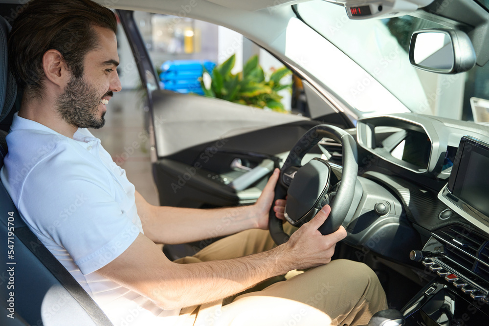 Joyful young buyer shopping for new car Joyful young buyer shopping for new car