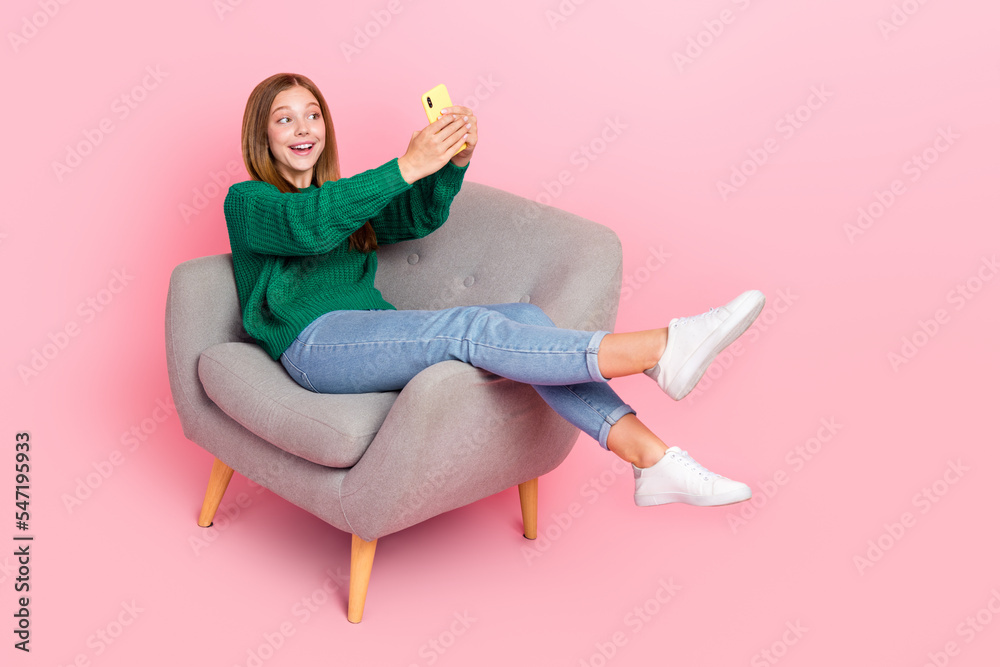 Full length photo of funny funky girl dressed knitted pullover recording self video isolated pink color background Full length photo of funny funky girl dressed knitted pullover recording self video isolated pink color background