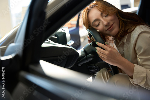 Young woman dozing off in her car