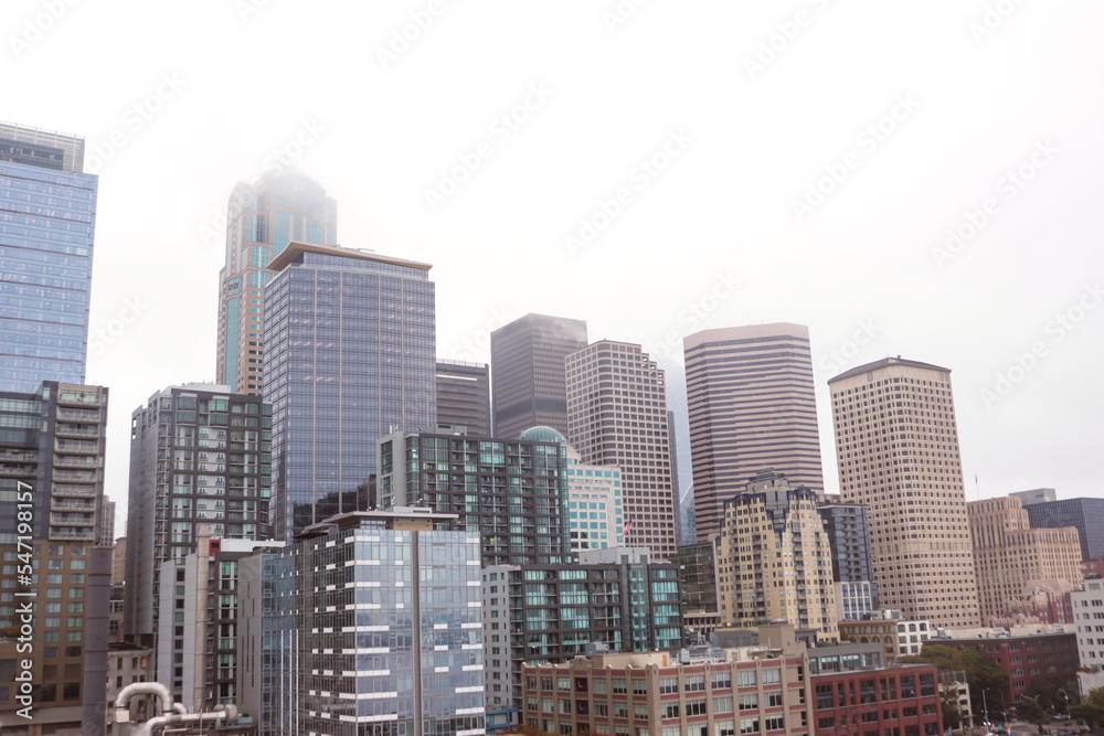 Seattle, Washington, USA- October 4, 2022: Downtown Seattle skyline cityscape building viewed from the waterfront on a gloomy fog sky day