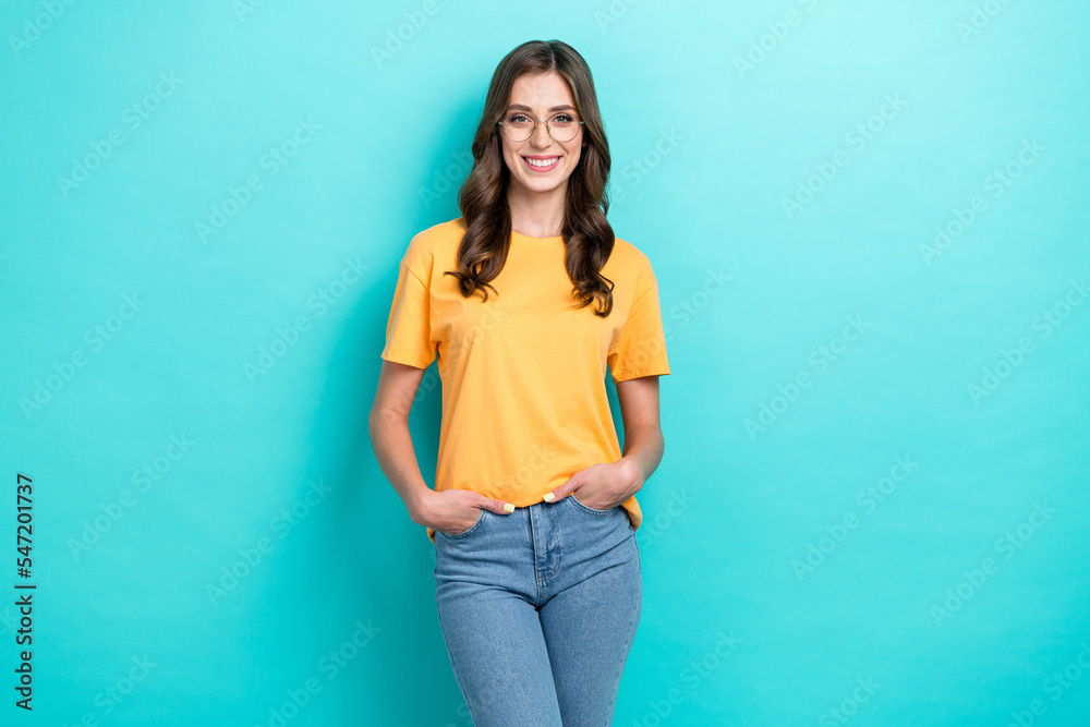 Photo of adorable pretty lady wear yellow t-shirt spectacles smiling isolated turquoise color background Photo of adorable pretty lady wear yellow t-shirt spectacles smiling isolated turquoise color background