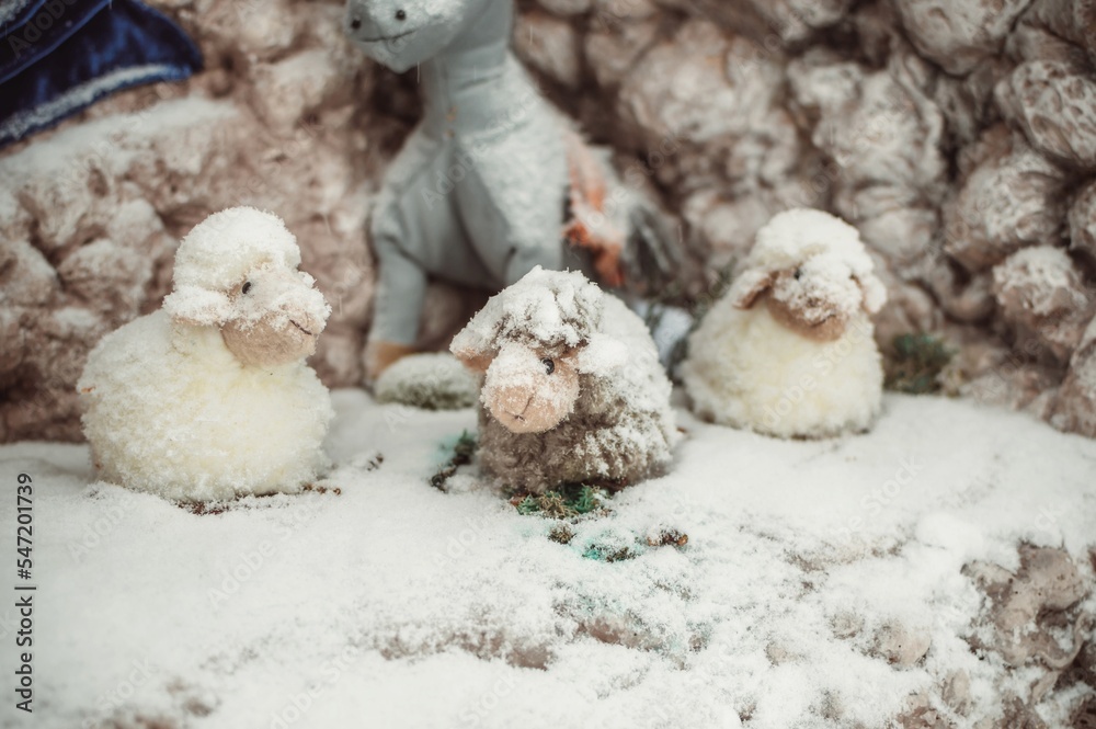 Toy sheeps under feathery snow in broach Toy sheeps under feathery snow in broach