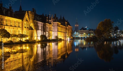 The Hague at night, Historical buildings at the Binnenhof complex, lake Hofvijver and the tower of The Great Church or St. James