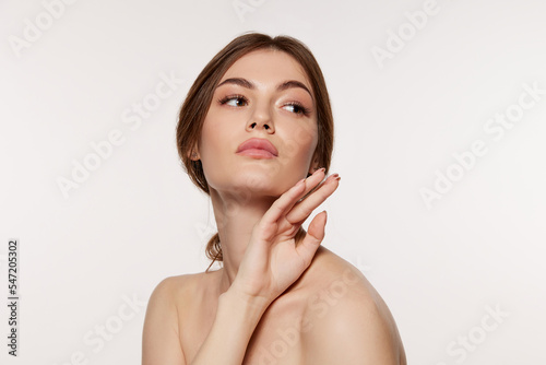 Portrait of young beautiful woman with perfect smooth skin isolated over white background