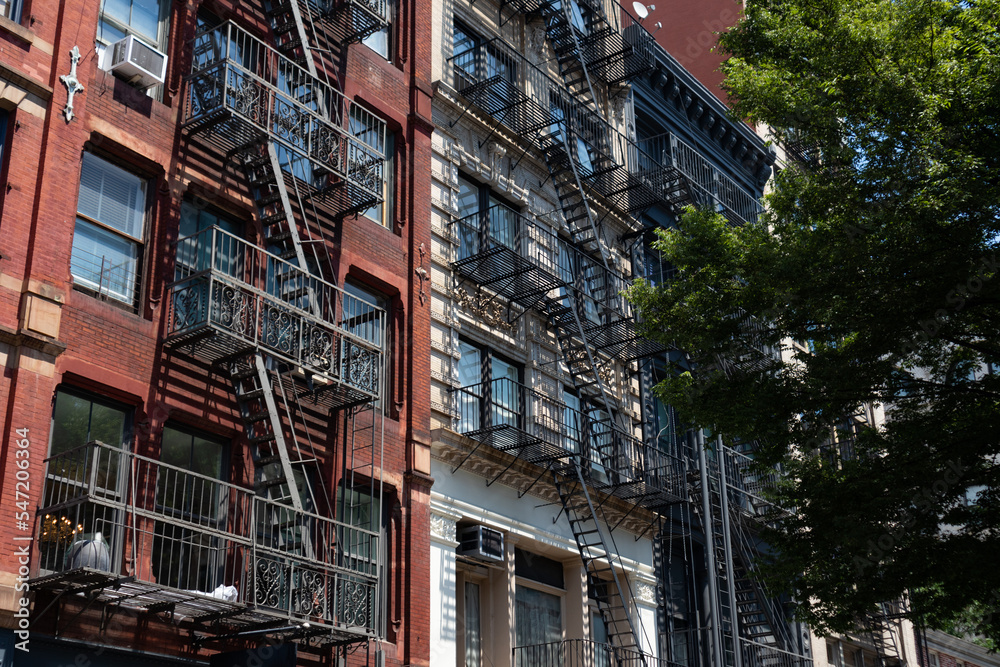 Row of Beautiful Old and Colorful Brick Apartment Buildings with Fire Escapes in SoHo of New York City